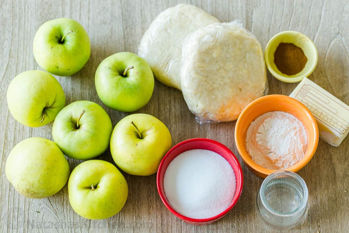 ingredients for Fall dessert using fruit, sugar, flour, butter, cinnamon, and pastry crust