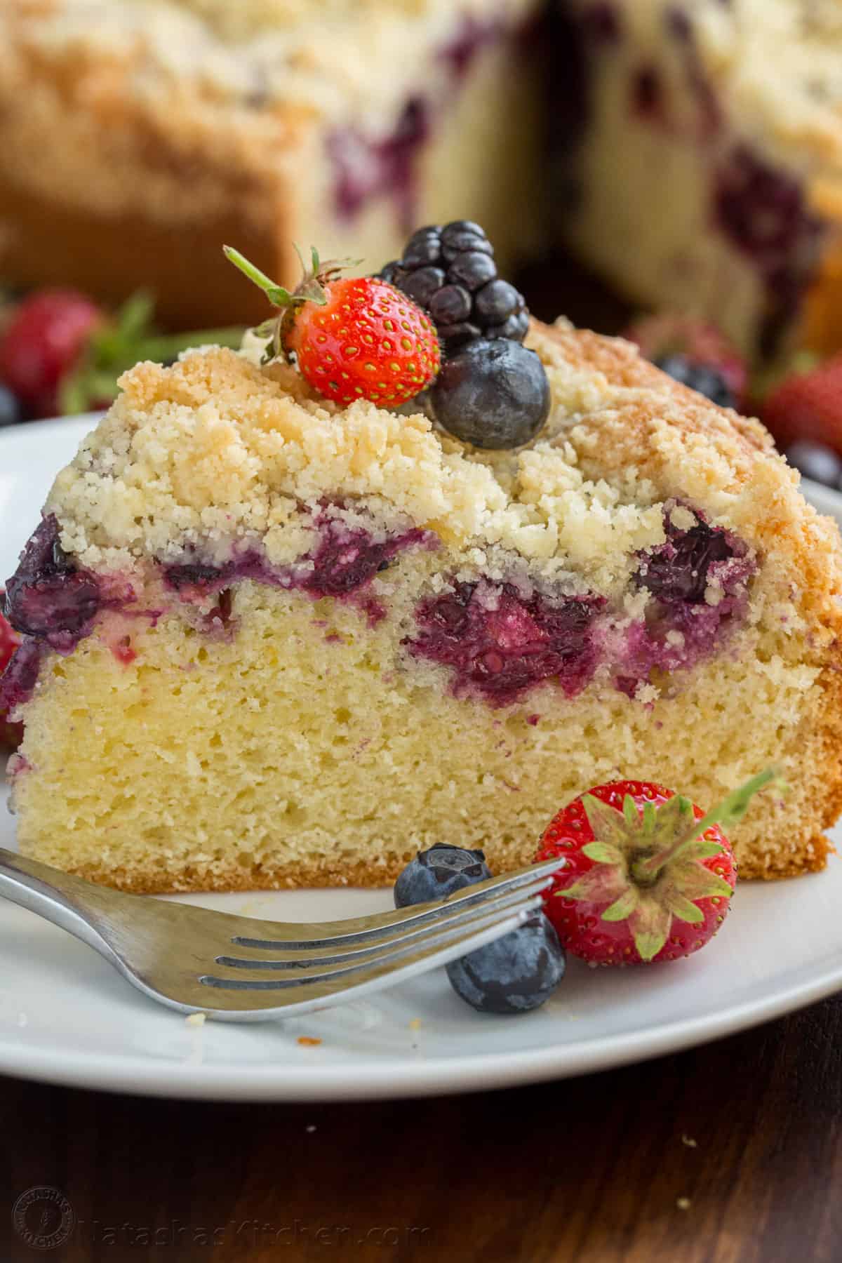 Slice of Berry cake on a plate garnished with berries