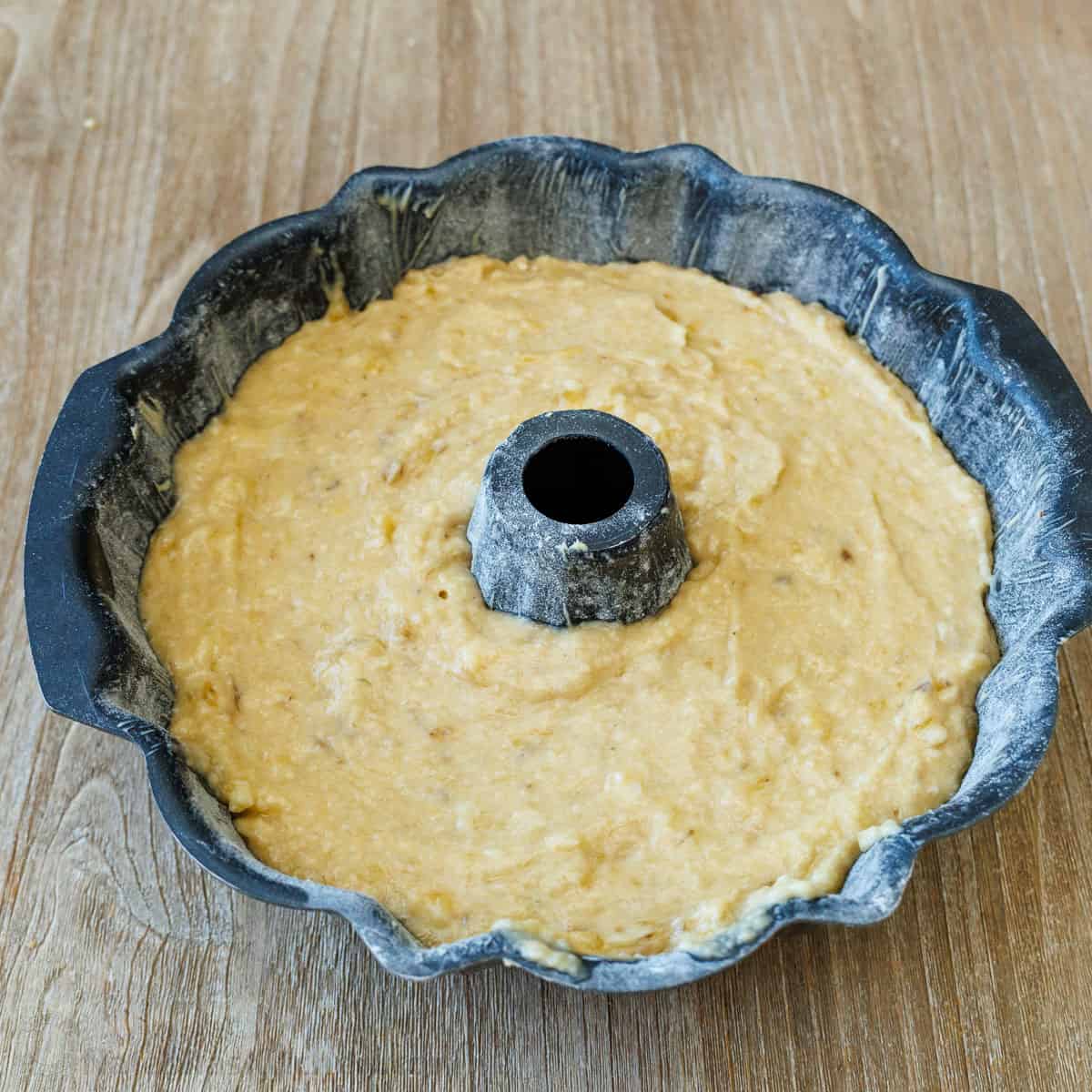 A bundt pan filled with banana cake batter