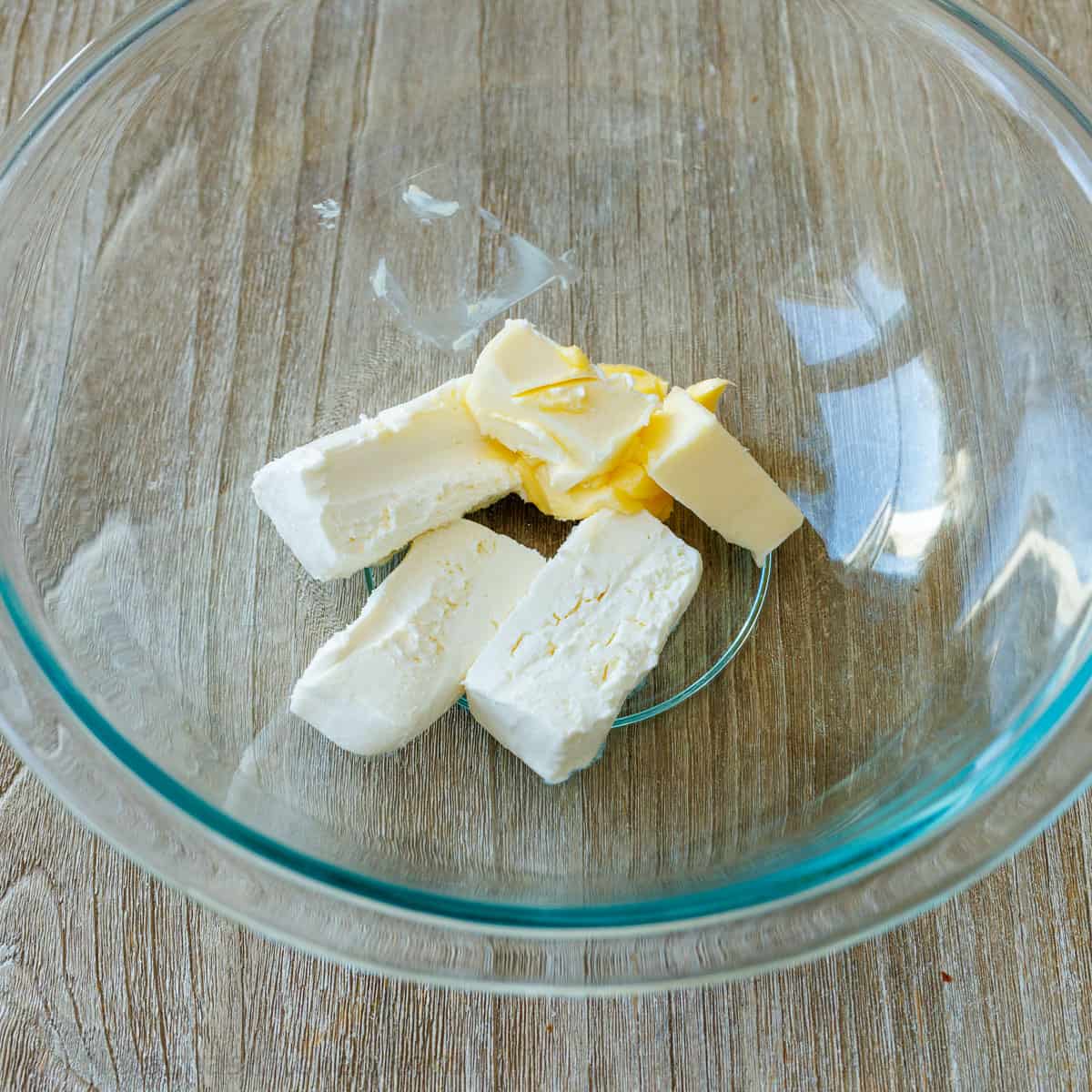 softened cream cheese and butter in a glass bowl