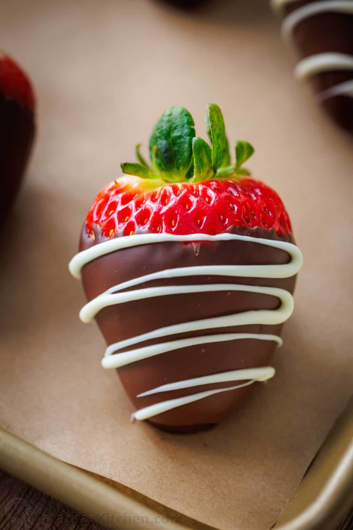 single close up of chocolate covered strawberry drizzled with chocolate