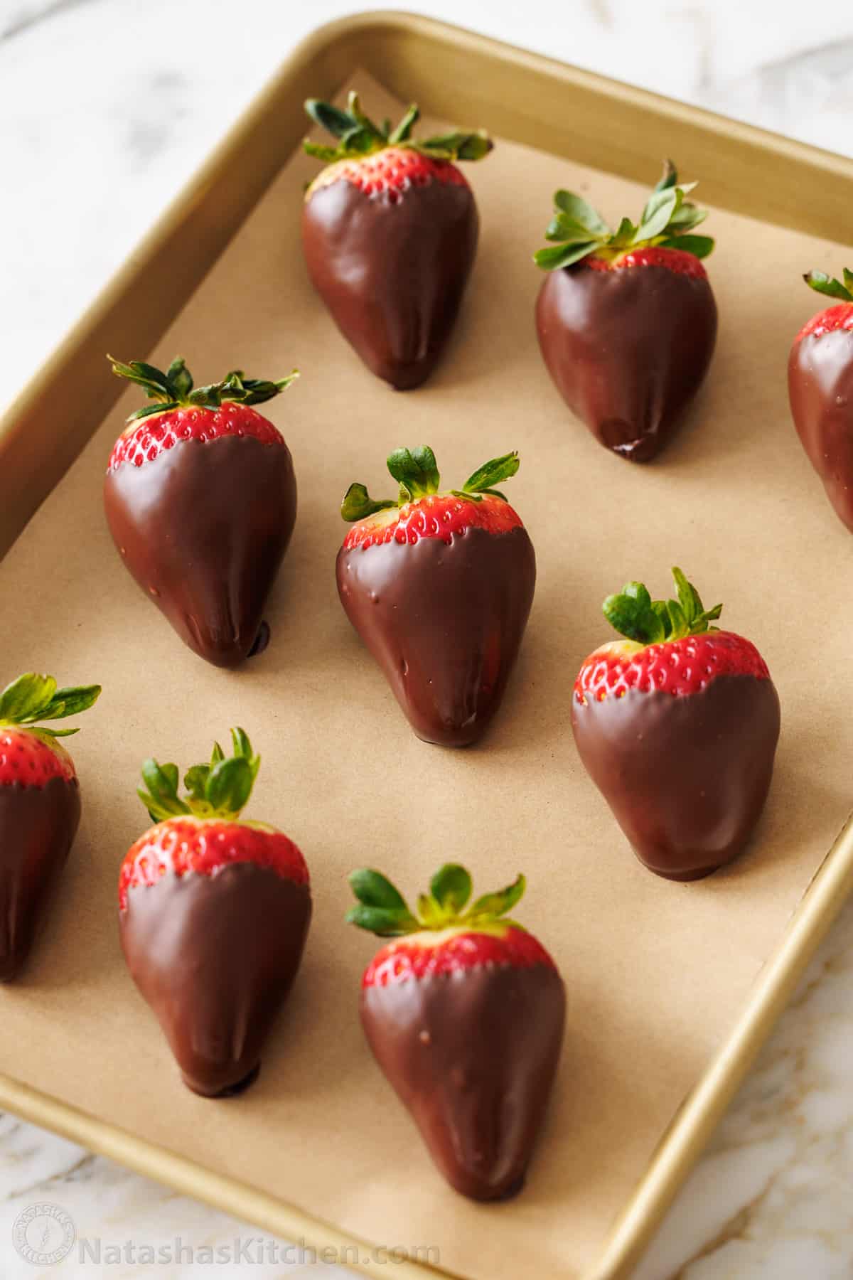 easy chocolate covered strawberries arranged on parchment paper