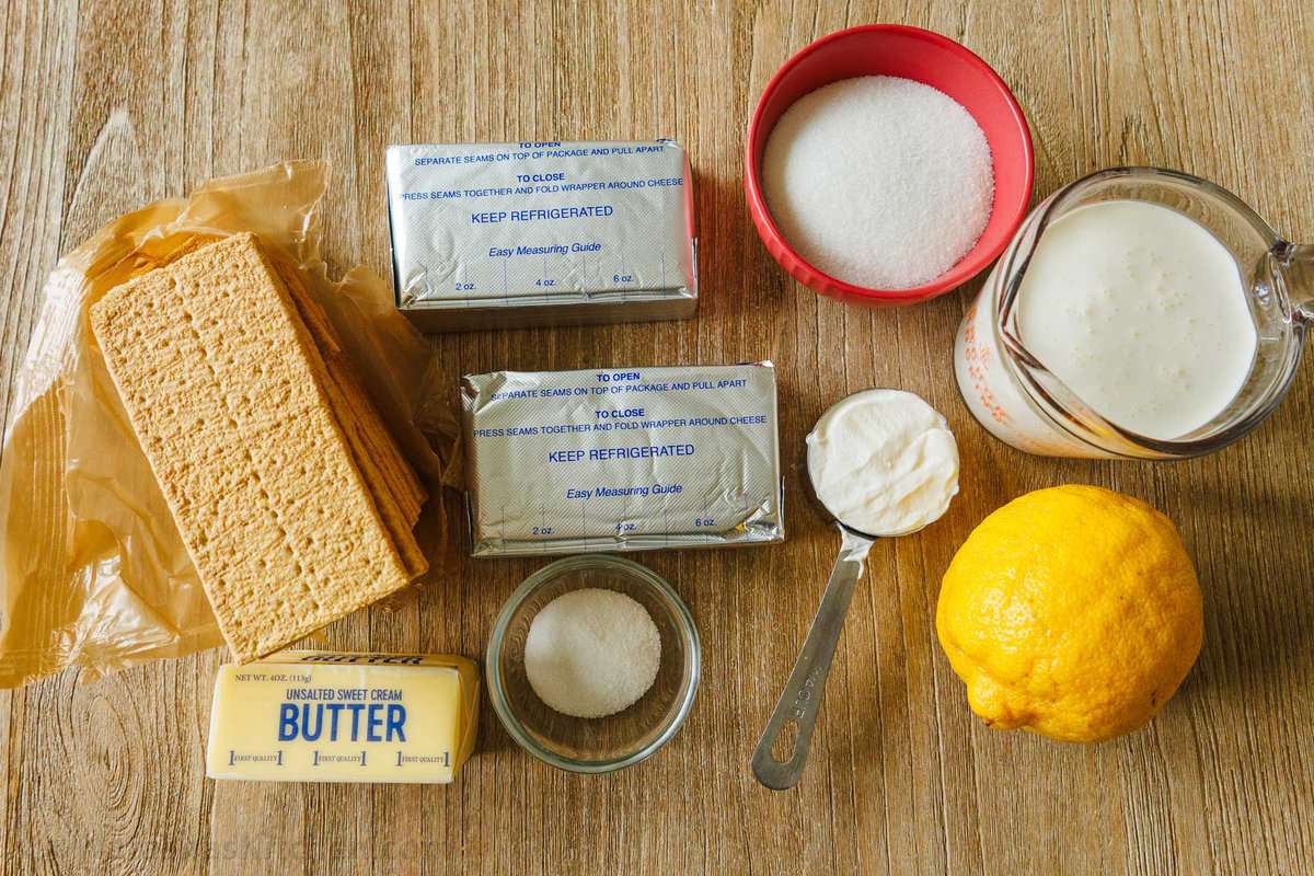 Ingredients to make no bake mini cheesecakes graham crackers, Philadelphia cream cheese, lemon, butter, sour cream, heavy whipping cream, sugar