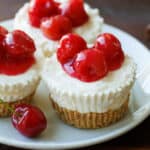 No bake mini cheesecakes with cherry topping on plate